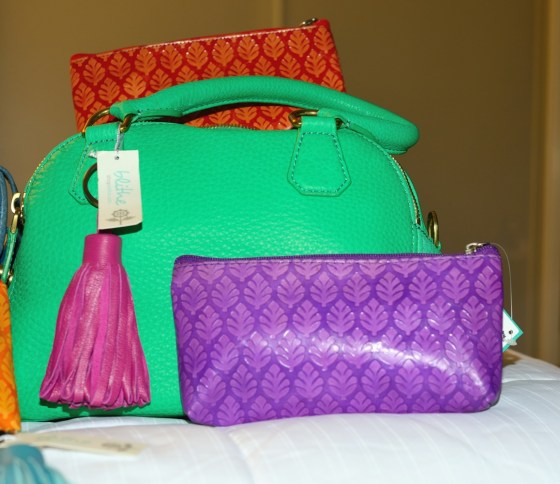 {Fuchsia Tassel Key Ring & Orange and Purple Neem Clutches, shown with green J. Crew Bag}